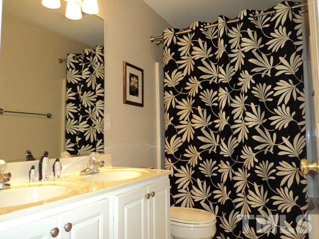 6900 Wilderness Road Raleigh, NC 27613 - Photo 16 of 25 a bathroom with a sink toilet and shower