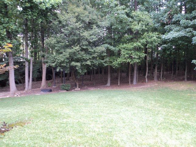 6900 Wilderness Road Raleigh, NC 27613 - Photo 21 of 25 a backyard of a house with table and chairs