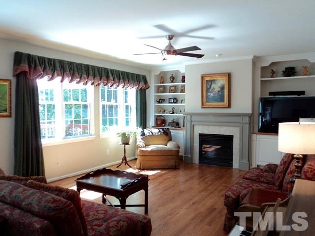 6900 Wilderness Road Raleigh, NC 27613 - Photo 5 of 25 a living room with furniture and a fireplace