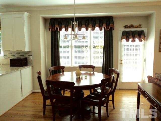 6900 Wilderness Road Raleigh, NC 27613 - Photo 10 of 25 a view of a dining room with furniture and window