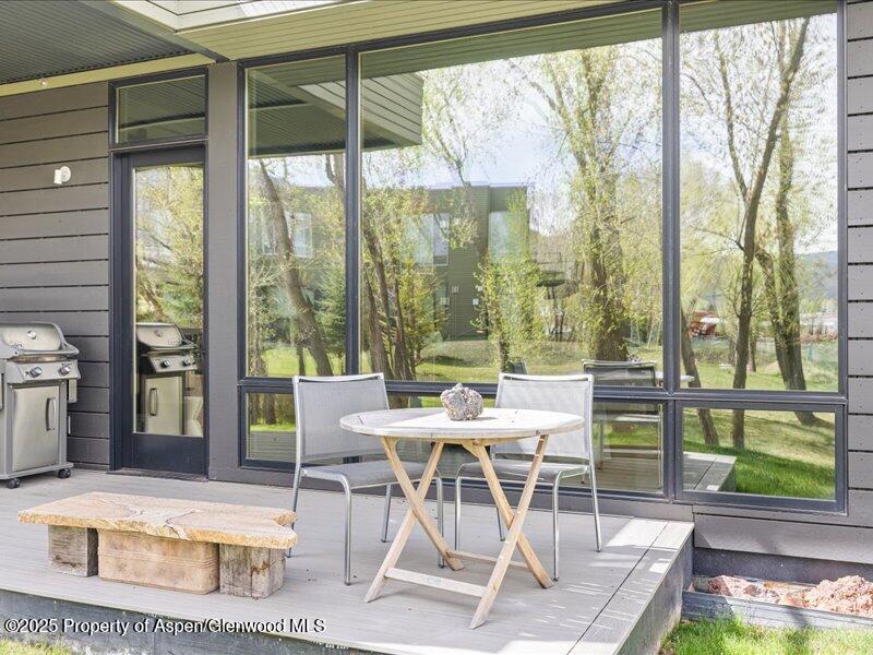 102 Evans Road, Unit 107 Basalt, CO 81621 - Photo 23 of 25 a dining room with furniture and a floor to ceiling window