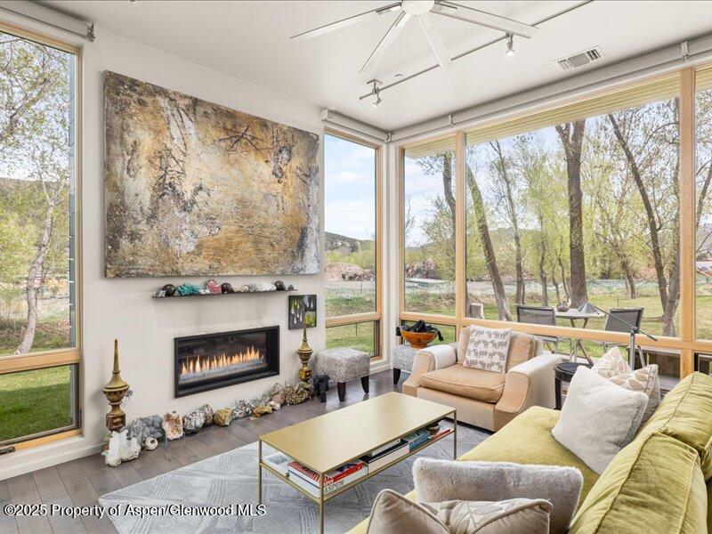 102 Evans Road, Unit 107 Basalt, CO 81621 - Photo 3 of 25 a living room with furniture large windows and a fireplace