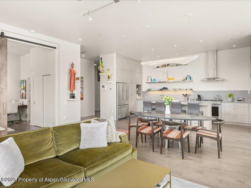 102 Evans Road, Unit 107 Basalt, CO 81621 - Photo 5 of 25 a living room with furniture and a dining table with kitchen view