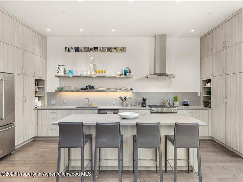 102 Evans Road, Unit 107 Basalt, CO 81621 - Photo 9 of 25 a kitchen with granite countertop a table chairs stove and cabinets