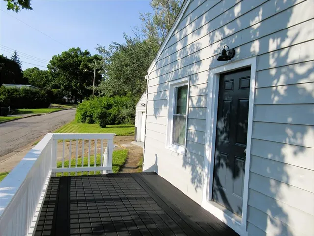an empty room with wooden floor and mirror in closet