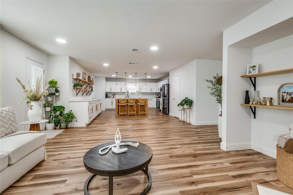 2416 Big Spring Drive Fort Worth, TX 76120 - Photo 11 of 36 a living room with furniture and a wooden floor