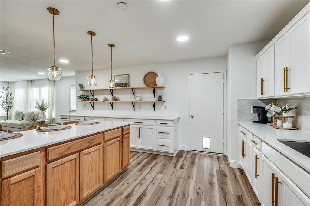 2416 Big Spring Drive Fort Worth, TX 76120 - Photo 14 of 36 a kitchen with white cabinets and sink