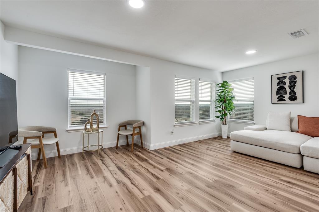 2416 Big Spring Drive Fort Worth, TX 76120 - Photo 19 of 36 a living room with furniture and a wooden floor