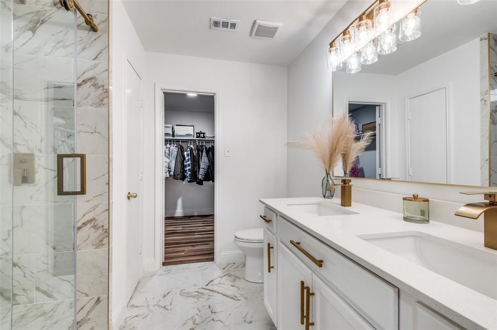 2416 Big Spring Drive Fort Worth, TX 76120 - Photo 27 of 36 a bathroom with a sink a toilet and shower