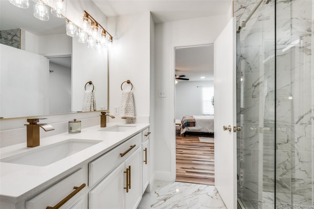 2416 Big Spring Drive Fort Worth, TX 76120 - Photo 28 of 36 a bathroom with a sink and a mirror