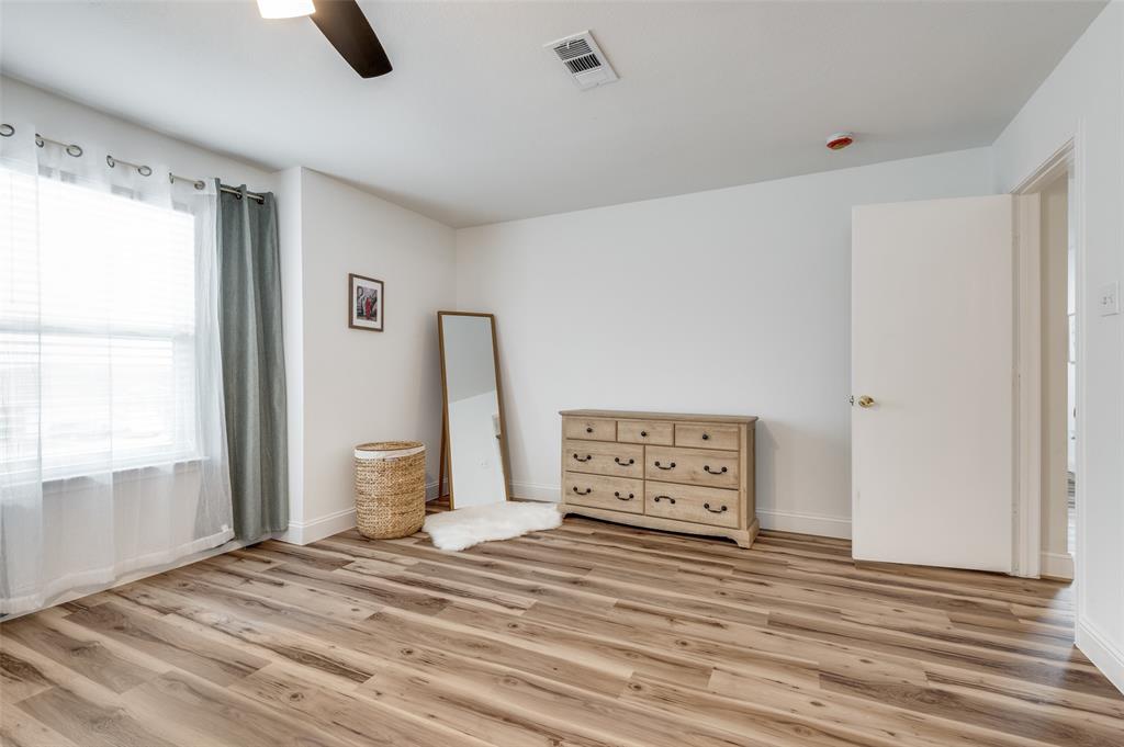 2416 Big Spring Drive Fort Worth, TX 76120 - Photo 30 of 36 a view of a bedroom with furniture and window