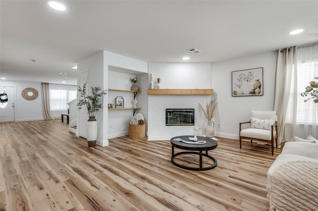 2416 Big Spring Drive Fort Worth, TX 76120 - Photo 9 of 36 a living room with furniture and a fireplace
