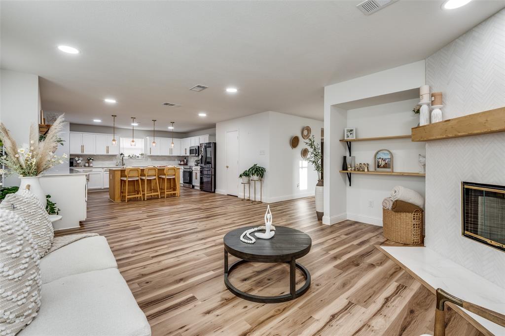 2416 Big Spring Drive Fort Worth, TX 76120 - Photo 10 of 36 a living room with furniture kitchen view and a wooden floor