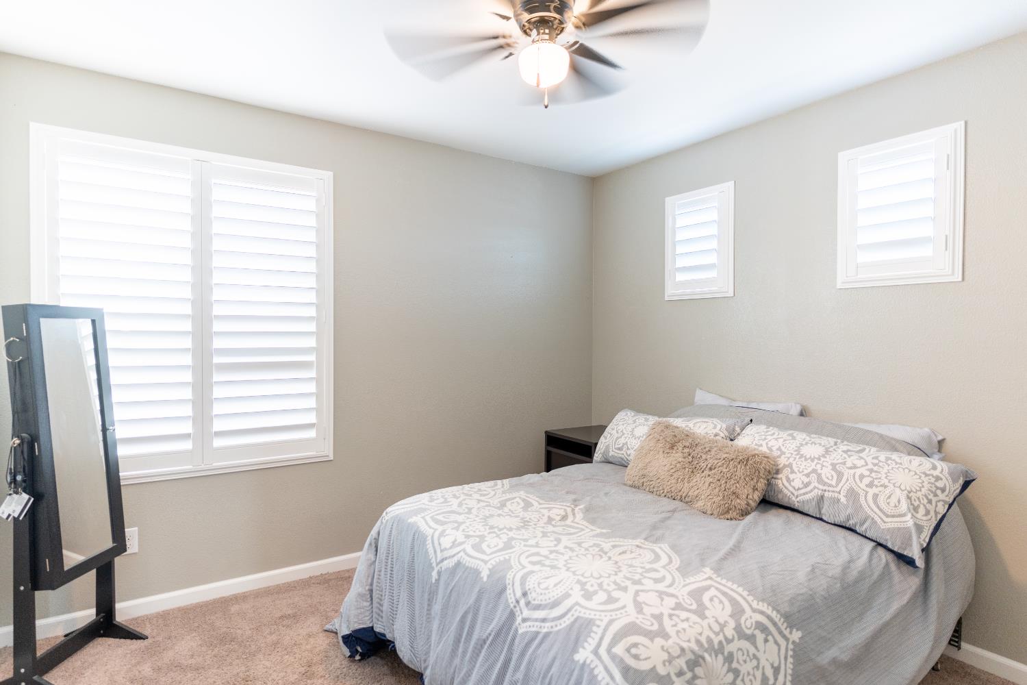 1358 Tevin Way Madera, CA 93637 - Photo 11 of 13 a bedroom with a bed and a window