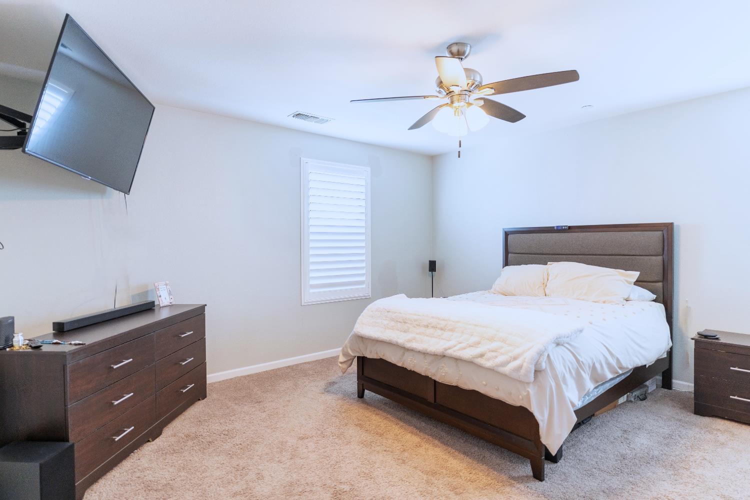 1358 Tevin Way Madera, CA 93637 - Photo 6 of 13 a bedroom with a bed and a ceiling fan