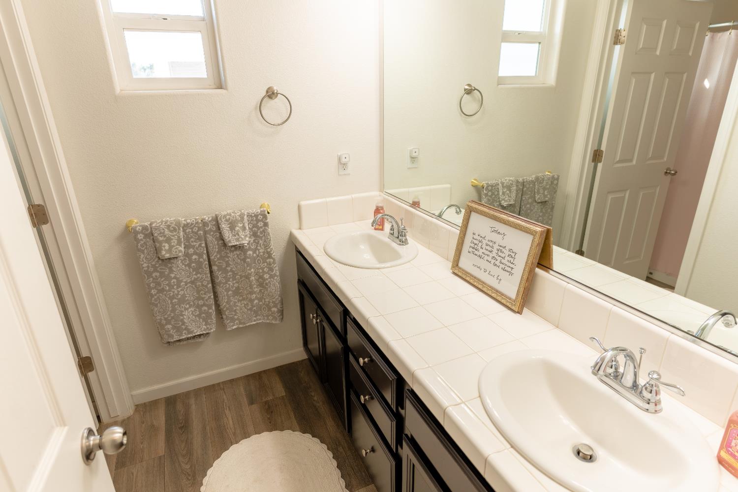 1358 Tevin Way Madera, CA 93637 - Photo 9 of 13 a bathroom with a sink mirror and vanity