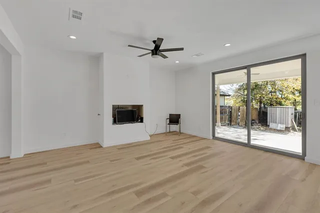 a kitchen with stainless steel appliances kitchen island a sink dishwasher a refrigerator and a stove with wooden floor