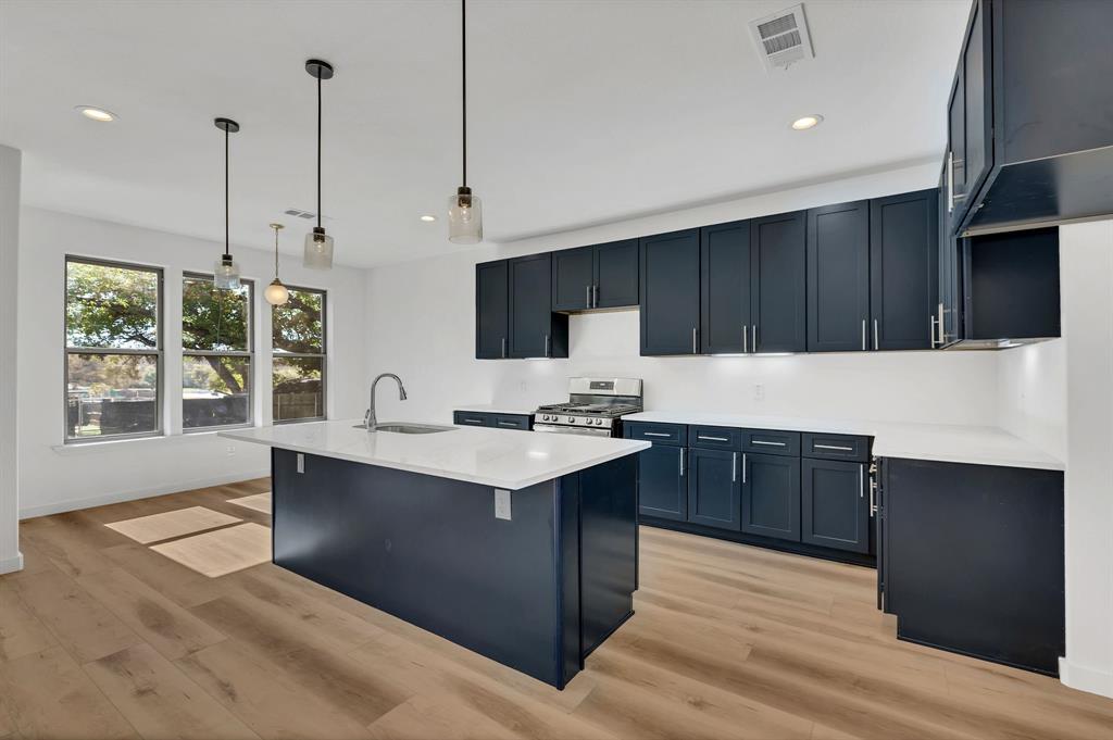 7305 Charbonneau Road Lake Worth, TX 76135 - Photo 14 of 40 a kitchen with a sink a window and stainless steel appliances