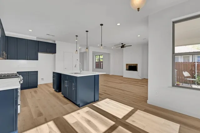 a kitchen with stainless steel appliances a sink stove and refrigerator