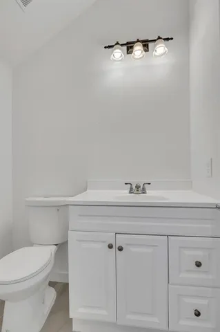 an empty room with a ceiling fan and window