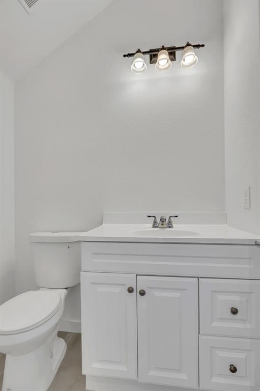 7305 Charbonneau Road Lake Worth, TX 76135 - Photo 23 of 40 a bathroom with a toilet and vanity