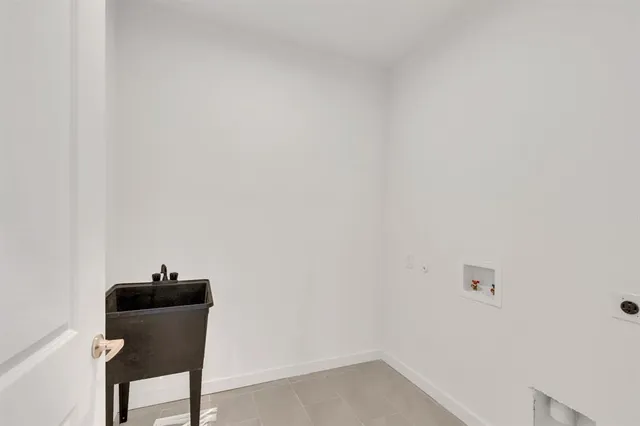 an empty room with ceiling fan and window