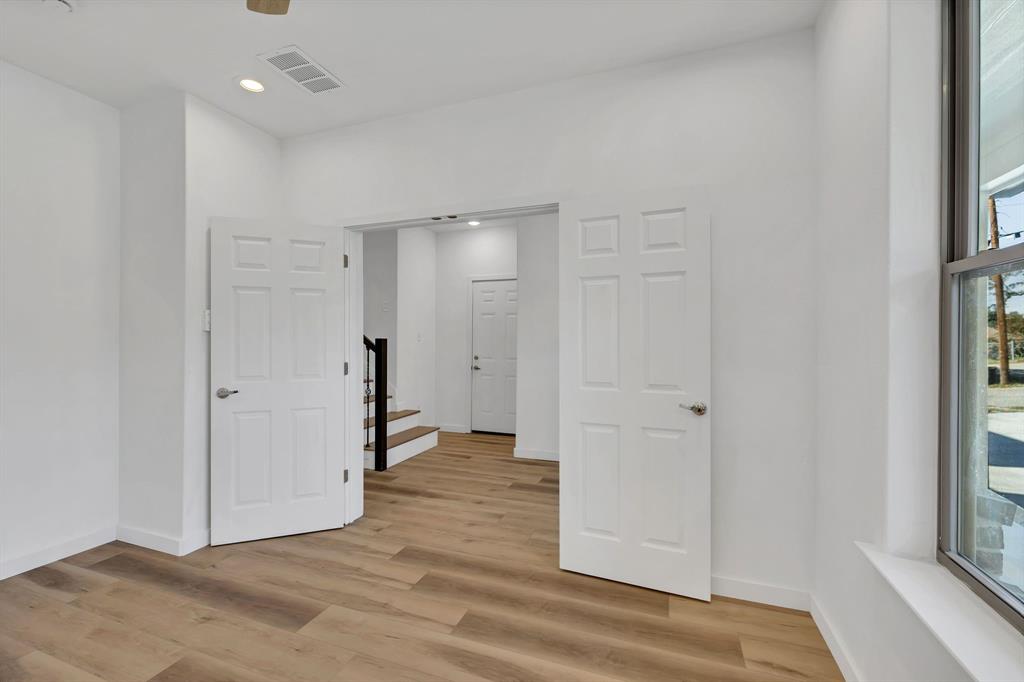 7305 Charbonneau Road Lake Worth, TX 76135 - Photo 8 of 40 a view of a hallway with wooden floor and a bathroom