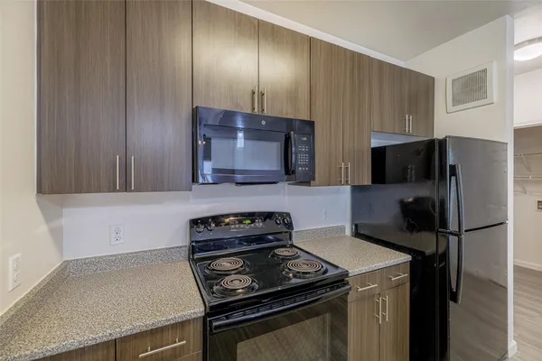 a kitchen with a refrigerator stove and microwave