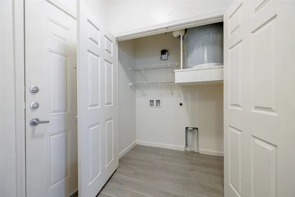 a view of walk in closet with wooden floor
