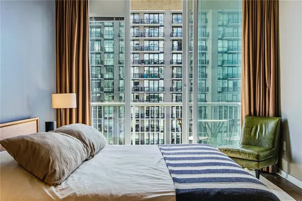 a bedroom with a bed and a window