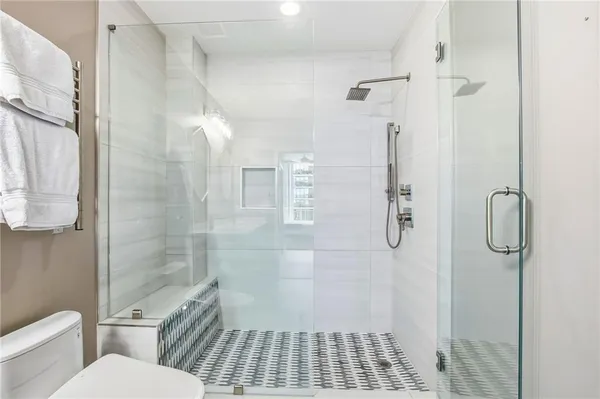 a bathroom with a toilet and a shower