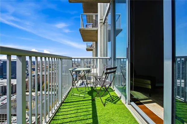 a view of a balcony with a dinning table and chairs