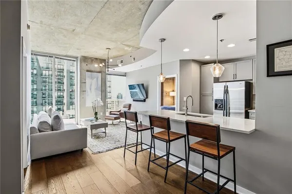 a living room with furniture wooden floor and a chandelier