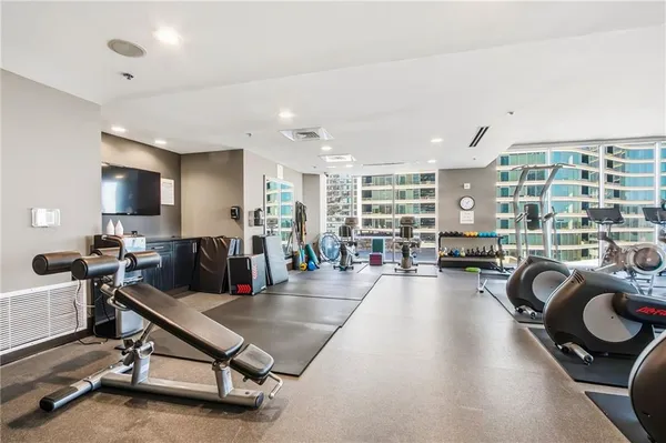 a view of a patio with couches table and chairs and potted plants