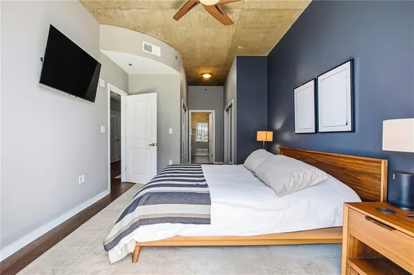 a bedroom with a bed and flat screen tv