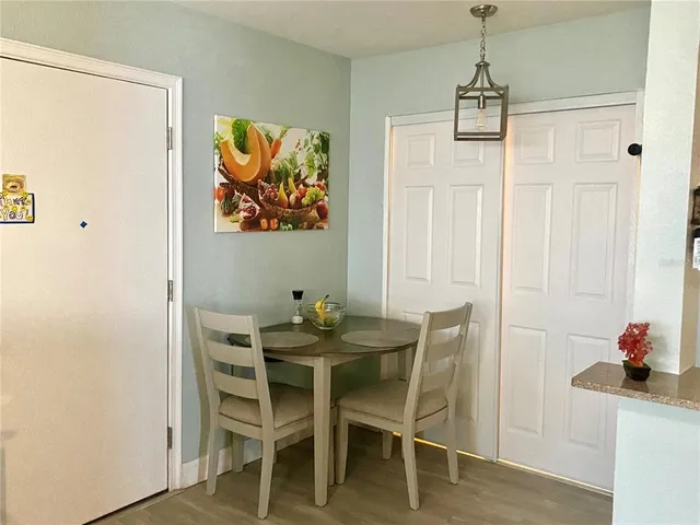 a view of a dining room with furniture and wooden floor