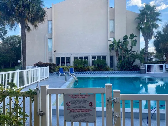 a view of swimming pool with outdoor seating and plants