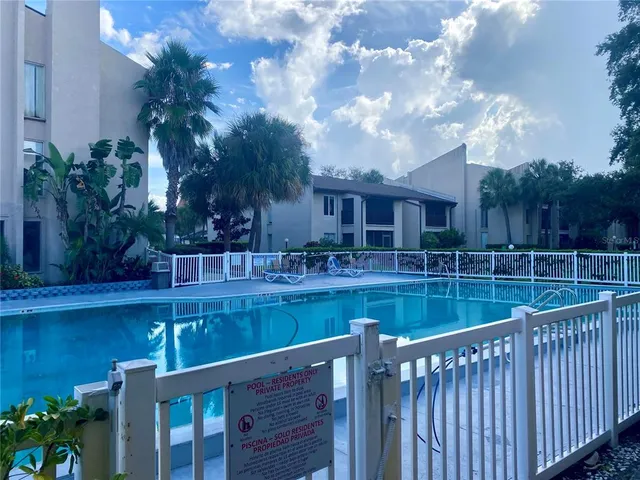 a view of swimming pool with outdoor seating and plants