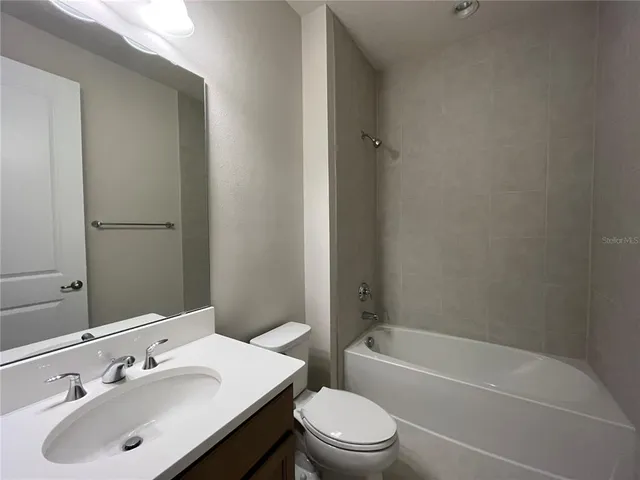 a bathroom with a sink toilet and bathtub