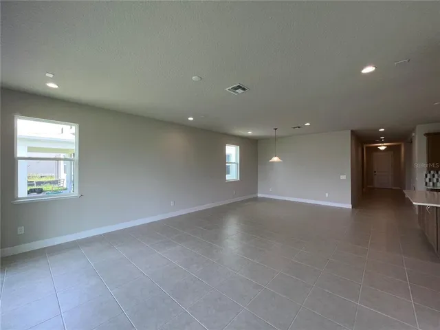 an empty room with windows and entrance