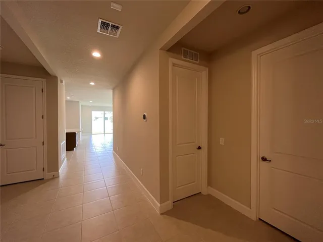 a view of a porch with a table and chairs with wooden fence