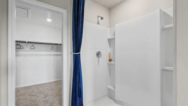 a bathroom with a double vanity sink mirror and shower