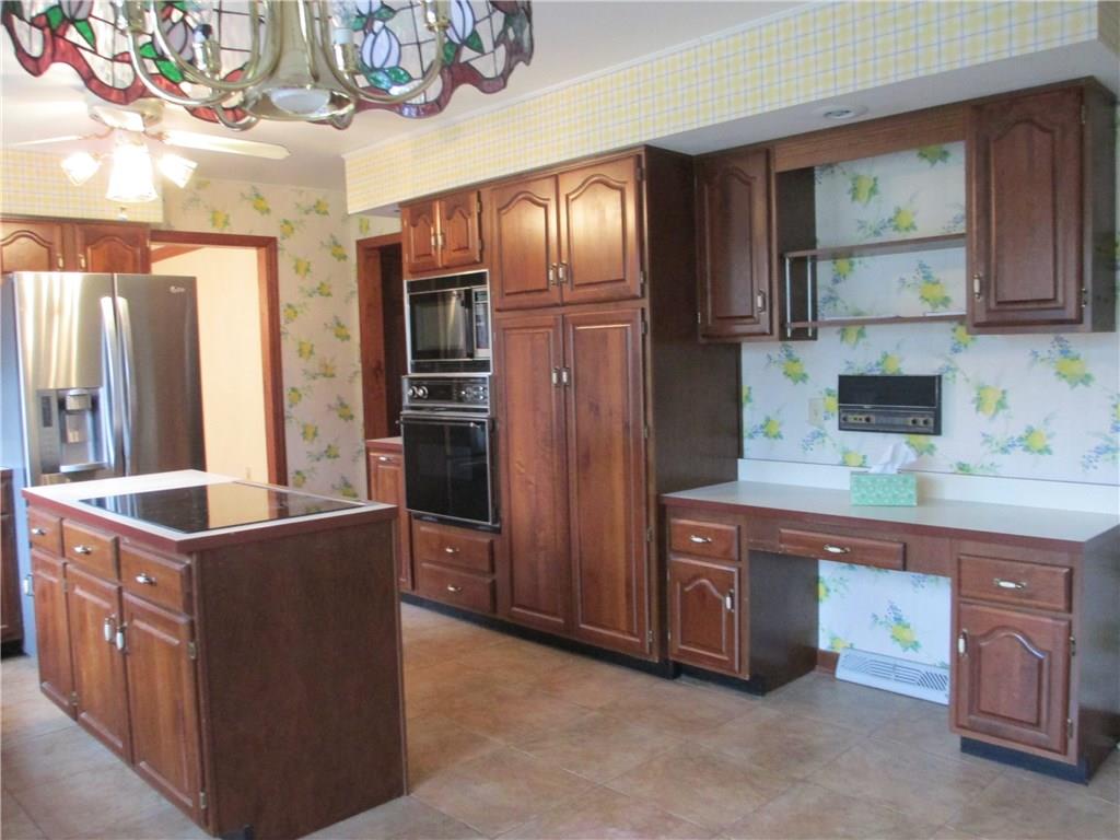 117 Parise Road Forest Hills, PA 15221 - Photo 16 of 23 a kitchen with stainless steel appliances granite countertop a refrigerator a stove and a wooden cabinets