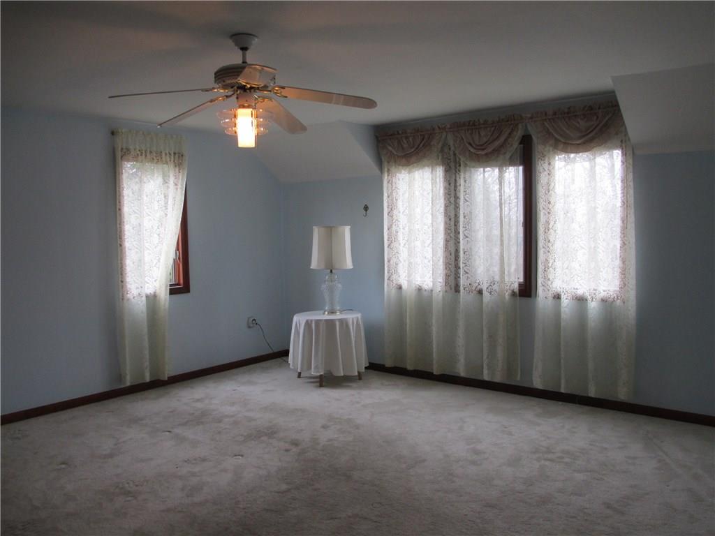 117 Parise Road Forest Hills, PA 15221 - Photo 20 of 23 an empty room with windows and chandelier fan