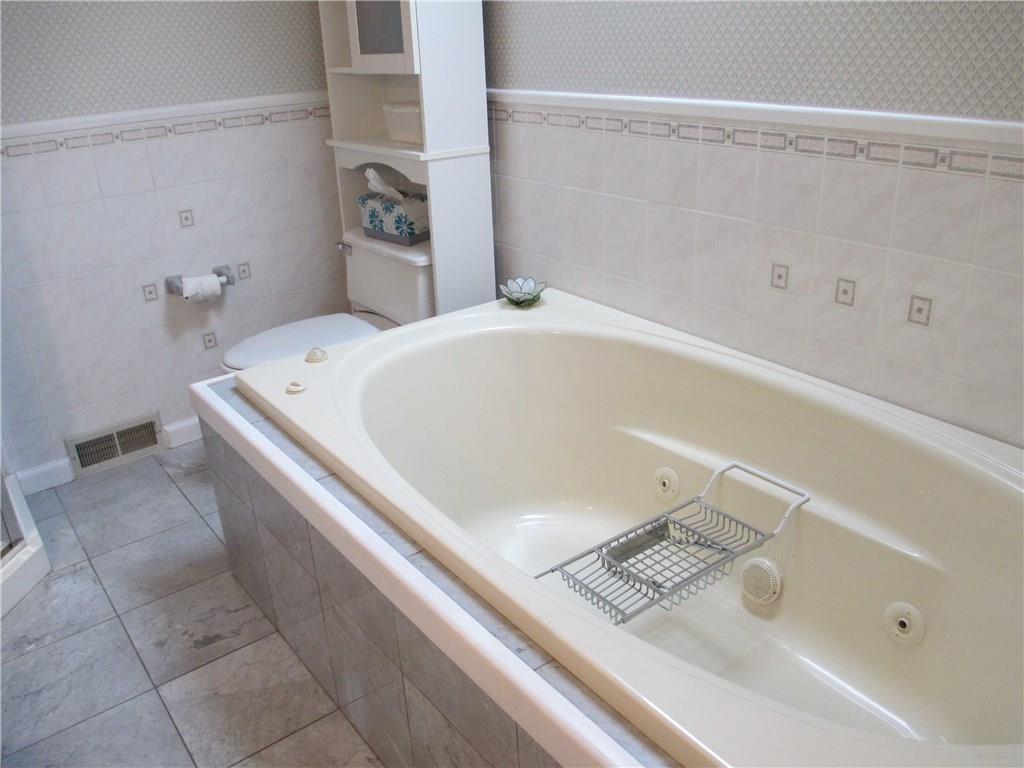 117 Parise Road Forest Hills, PA 15221 - Photo 22 of 23 a bath tub sitting next to a white sink and vanity
