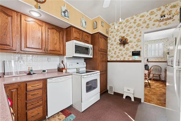 a kitchen with stainless steel appliances granite countertop a stove and a sink
