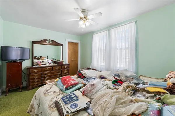 a bedroom with bed and a chandelier