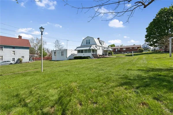 a view of a big yard with a house and a garden