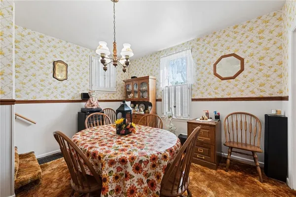 a dining room with furniture and window