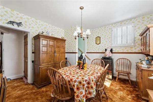 a dining room with furniture and chandelier